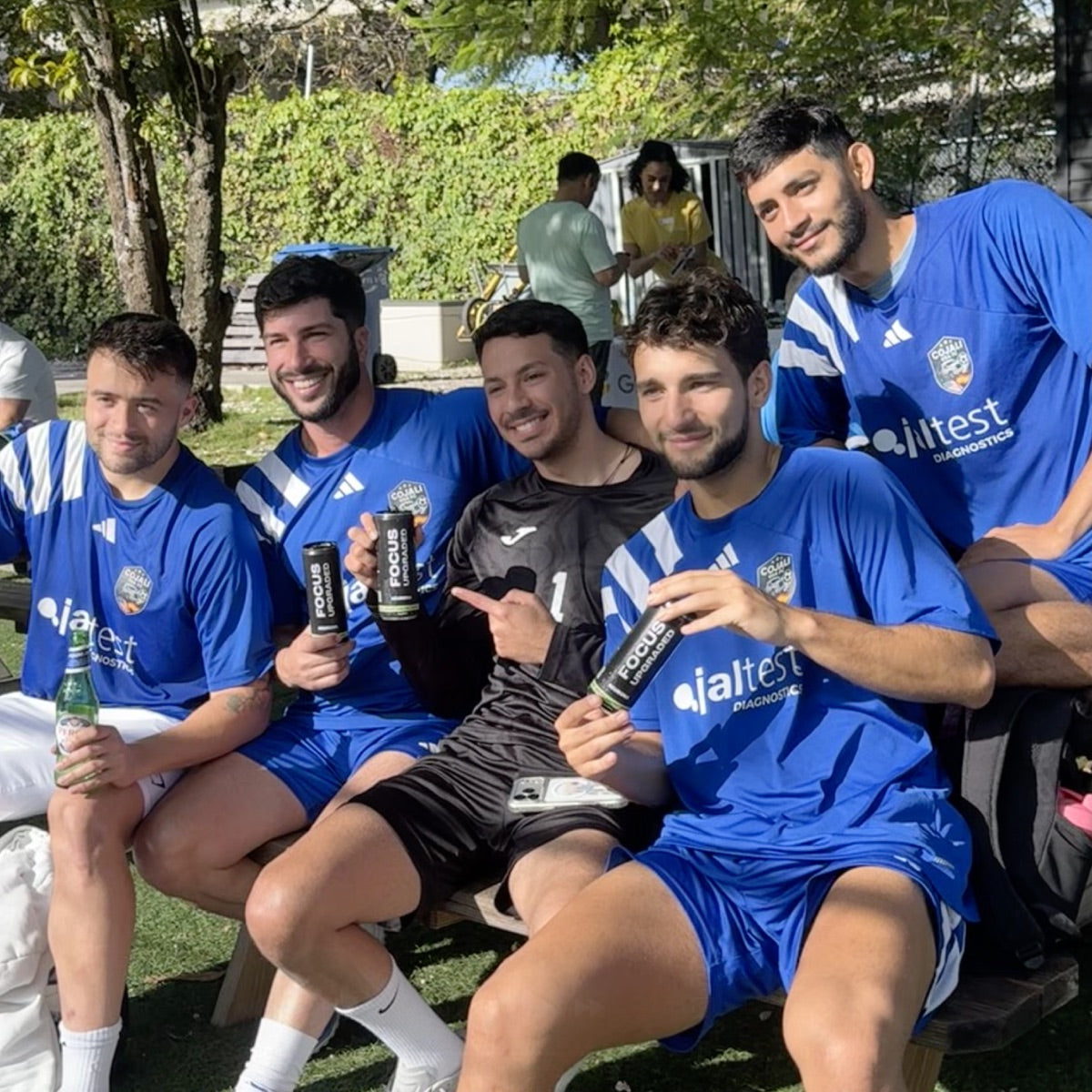 Soccer team holding Neurona cans