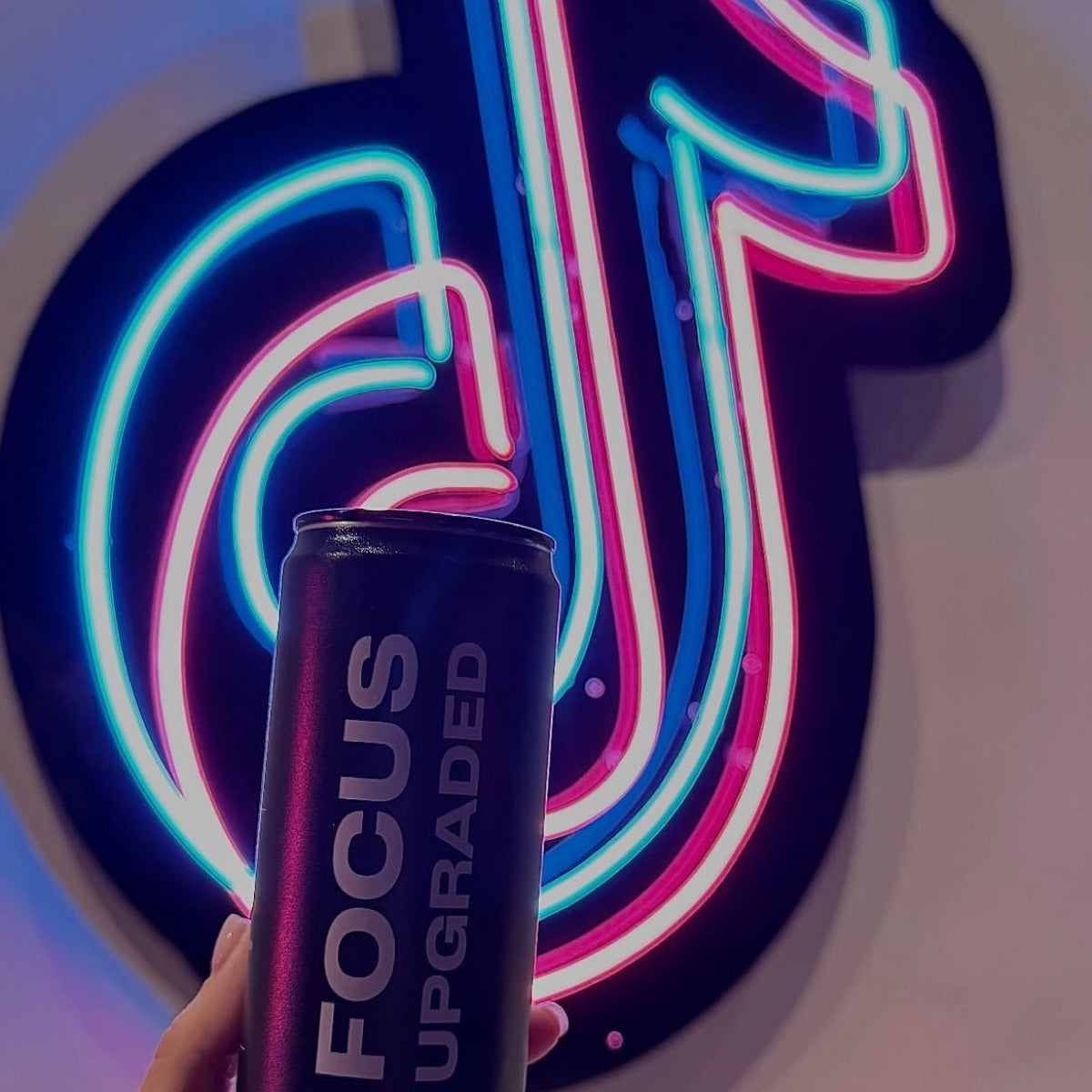 Neurona can in front of a neon TikTok sign
